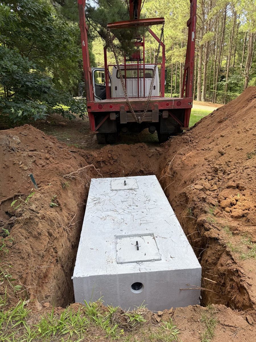 New concrete tank set with our skid steer — Forsyth County install.